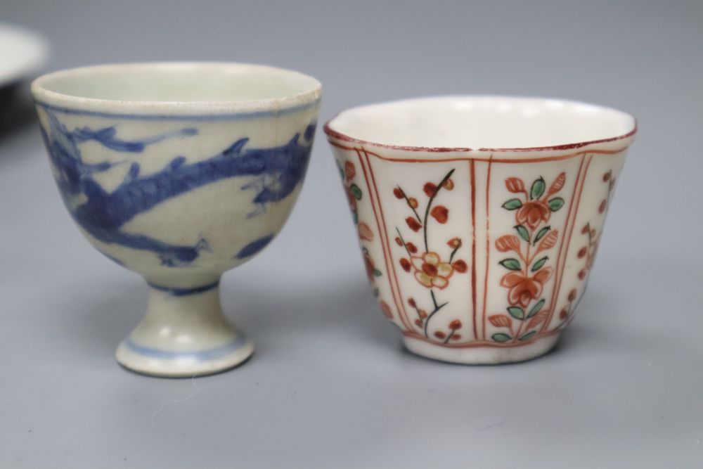 An Arita Dutch decorated saucer, 17th century, a Chinese Dehua Dutch decorated wine cup and a Nanking cargo stem cup